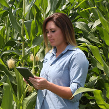 girl working on an ipad in field